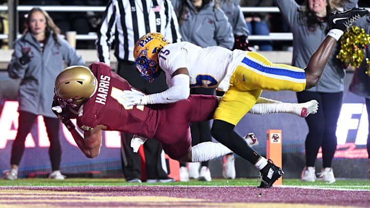 Nov 30, 2024; Chestnut Hill, Massachusetts, USA; Boston College Eagles wide receiver Reed Harris (4) makes a catch for a touchdown in front of Pittsburgh Panthers defensive back Rashad Battle (15) during the second half at Alumni Stadium. Mandatory Credit: Brian Fluharty-Imagn Images