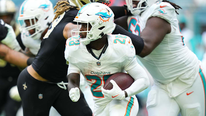 Miami Dolphins running back De'Von Achane (28) carries the ball against the New Orleans Saints during the second half at Hard Rock Stadium. 