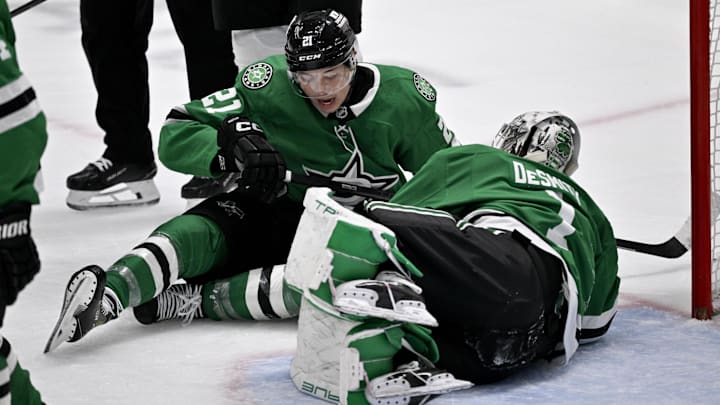 Apr 12, 2025; Dallas, Texas, USA; Dallas Stars left wing Jason Robertson (21) collides with goaltender Casey DeSmith (1) during the third period at the American Airlines Center. Mandatory Credit: Jerome Miron-Imagn Images