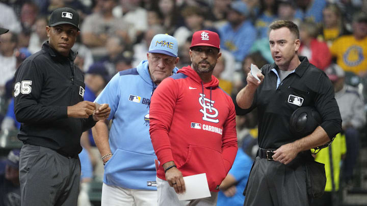Sep 12, 2025; Milwaukee, Wisconsin, USA; Milwaukee Brewers manager Pat Murphy (49) and St. Louis Cardinals manager Oliver Marmol (37) go over the parameters of the playing field with home plate umpire Hanahan before their game at American Family Field. Also pictured is third base umpire Jeramie Rehak. Mandatory Credit: Michael McLoone-Imagn Images