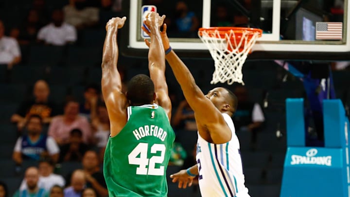 Oct 11, 2017; Charlotte, NC, USA; Boston Celtics center Al Horford (42) shoots the ball over Charlotte Hornets center Dwight Howard (12) in the first half at Spectrum Center. Mandatory Credit: Jeremy Brevard-Imagn Images