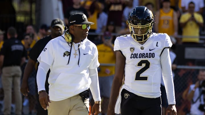 Colorado Buffaloes head coach Deion Sanders with son and quarterback Shedeur Sanders (2) against the Arizona State Sun Devils at Mountain America Stadium.