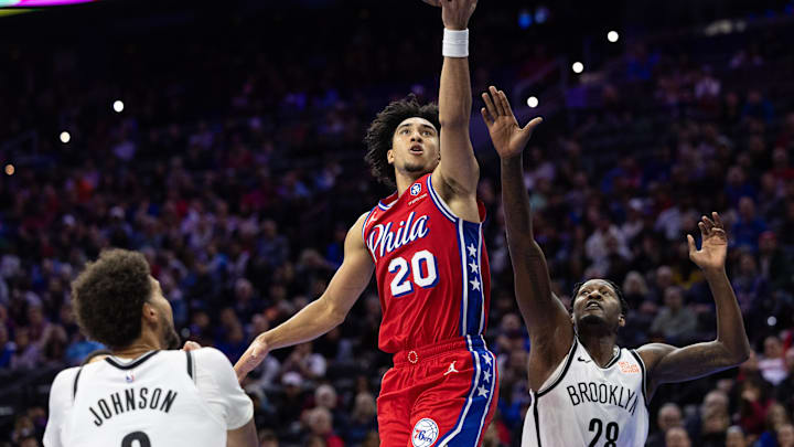 Nov 22, 2024; Philadelphia, Pennsylvania, USA; Philadelphia 76ers guard Jared McCain (20) drives for a score past Brooklyn Nets forward Cameron Johnson (2) and forward Dorian Finney-Smith (28) during the fourth quarter at Wells Fargo Center. Mandatory Credit: Bill Streicher-Imagn Images