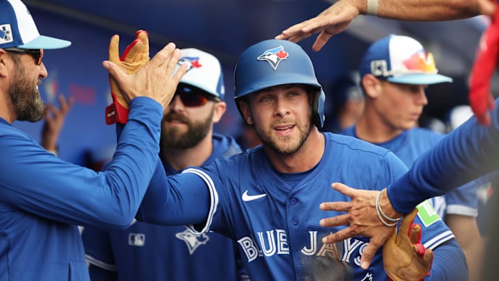 Feb 22, 2025:  Toronto Blue Jays third base Ernie Clement (22) is congratulated after scoring a run during the second inning against the New York Yankees  at TD Ballpark. 