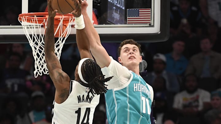 Oct 22, 2025; Charlotte, North Carolina, USA; Charlotte Hornets center Ryan Kalkbrenner (11) fouls Brooklyn Nets forward Terance Mann (14) during the second half at the Spectrum Center. Mandatory Credit: Sam Sharpe-Imagn Images Oct 22, 2025; Charlotte, North Carolina, USA; Charlotte Hornets center Ryan Kalkbrenner (11) fouls Brooklyn Nets forward Terance Mann (14) during the second half at the Spectrum Center. Mandatory Credit: Sam Sharpe-Imagn Images