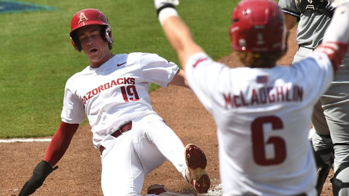 May 22 2024; Hoover, AL, USA; Arkansas base runner Will Edmunson slide home with a run against South Carolina at the Hoover Met during the SEC Tournament.