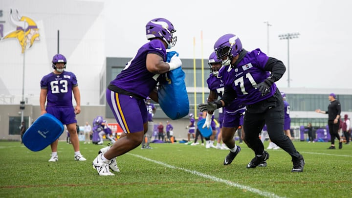 Christian Darrisaw practices with over Vikings offensive linemen at minicamp. Christian Darrisaw practices with over Vikings offensive linemen at minicamp.