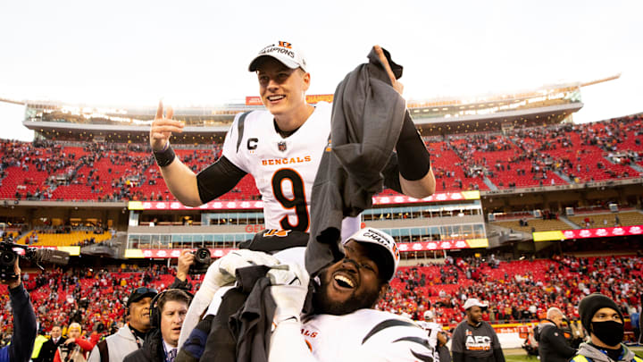 Cincinnati Bengals defensive tackle Tyler Shelvin lifts up Cincinnati Bengals quarterback Joe Burrow.