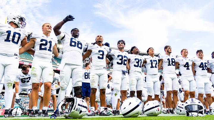 Penn State Nittany Lions football players lock arms and listen to the alma mater after defeating Temple 27-9. 