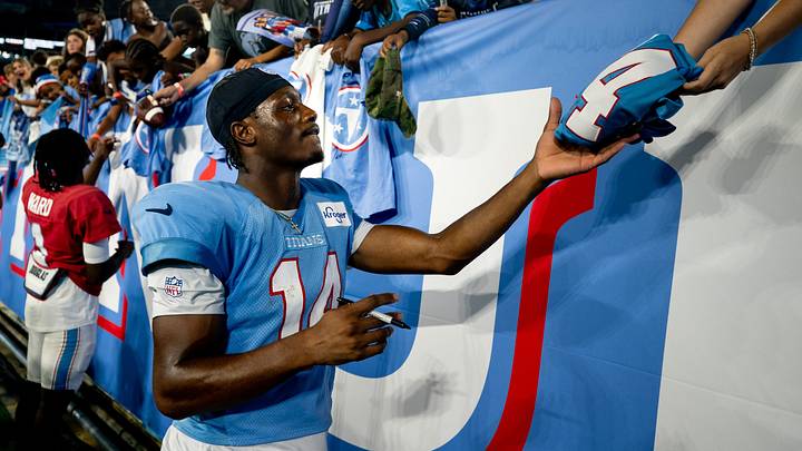 Tennessee Titans wide receiver Carnell Tate (14) signs autographs after the Blue and White Stadium Scrimmage at Nissan Stadium in Nashville, Tenn., Friday, Aug. 7, 2026.