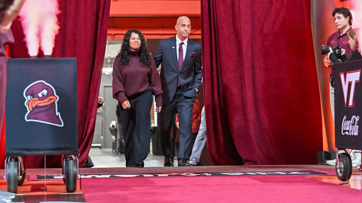 Nov 19, 2025; Blacksburg, VA, USA;  Virginia Tech football coach James Franklin and his wife Fumi enter press conference where he is introduced as head coach at Cassell Coliseum. Mandatory Credit: Brian Bishop-Imagn Images