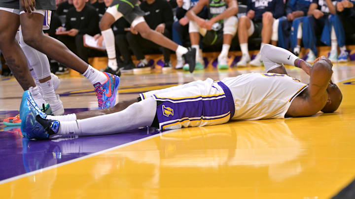 Apr 19, 2025; Los Angeles, California, USA; Los Angeles Lakers forward LeBron James (23) reacts after taking an elbow from Minnesota Timberwolves forward Julius Randle (30) in the second half at Crypto.com Arena. Mandatory Credit: Jayne Kamin-Oncea-Imagn Images