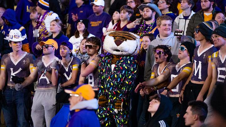 Nov 30, 2024; Baton Rouge, Louisiana, USA;  LSU Tigers mascot Mike the Tiger cheers with the student section against the Oklahoma Sooners during the second quarter at Tiger Stadium. Mandatory Credit: Stephen Lew-Imagn Images