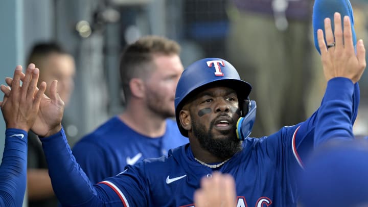 Jun 13, 2024; Los Angeles, California, USA;  Texas Rangers right fielder Adolis Garcia #53 is greeted in the dugout after scoring a run in the third inning against the Los Angeles Dodgers at Dodger Stadium. Mandatory Credit: Jayne Kamin-Oncea-USA TODAY Sports