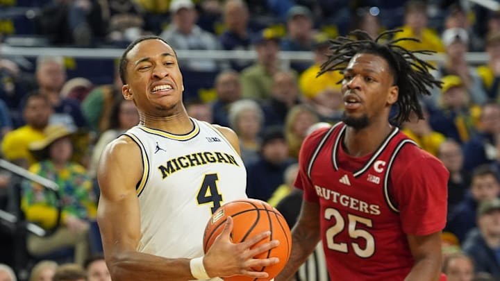Michigan Wolverines guard Nimari Burnett (4) is fouled by Rutgers Scarlet Knights guard Jeremiah Williams (25) during the first half at Crisler Center in Ann Arbor on Thursday, Feb. 27, 2025.