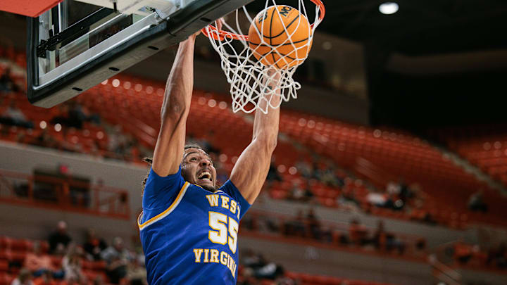 Feb 24, 2026; Stillwater, Oklahoma, USA; West Virginia Mountaineers center Harlan Obioha (55) dunks during the first half against the Oklahoma State Cowboys at Gallagher-Iba Arena. Mandatory Credit: William Purnell-Imagn Images
