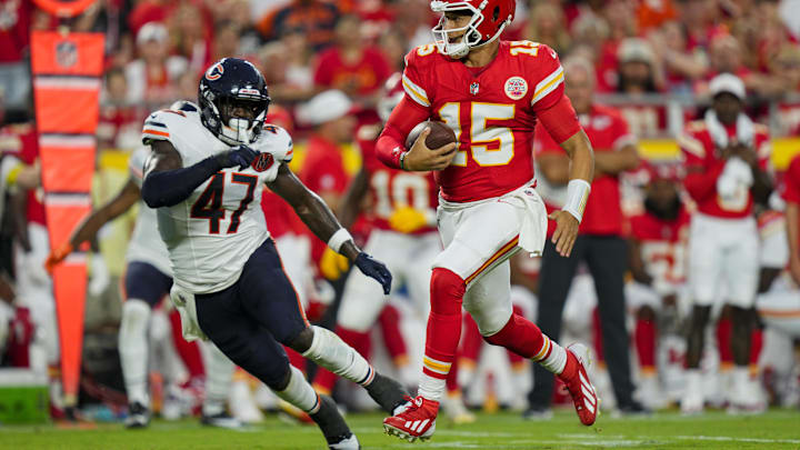 Aug 22, 2025; Kansas City, Missouri, USA; Kansas City Chiefs quarterback Patrick Mahomes (15) runs the ball against Chicago Bears linebacker Ruben Hyppolite II (47) during the first half at GEHA Field at Arrowhead Stadium. Mandatory Credit: Jay Biggerstaff-Imagn Images