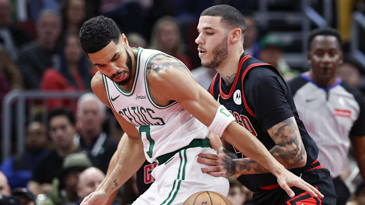 Nov 29, 2024; Chicago, Illinois, USA; Chicago Bulls guard Lonzo Ball (2) defends against Boston Celtics forward Jayson Tatum (0) during the first half at United Center. Mandatory Credit: Kamil Krzaczynski-Imagn Images