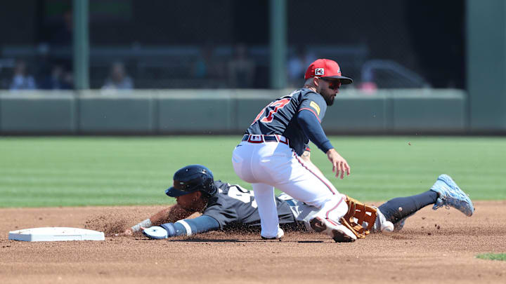 Mar 2, 2025; North Port, Florida, USA;  New York Yankees third base Oswaldo Cabrera (95) steals second base as Atlanta Braves infielder Eddy Alvarez (87)  attempted to tag him out during the second inning at CoolToday Park. 
