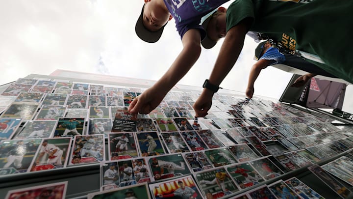 Children collect and trade Topps Baseball Cards outside Howard J. Lamade Stadium in Williamsport, Pa., in August 2023.