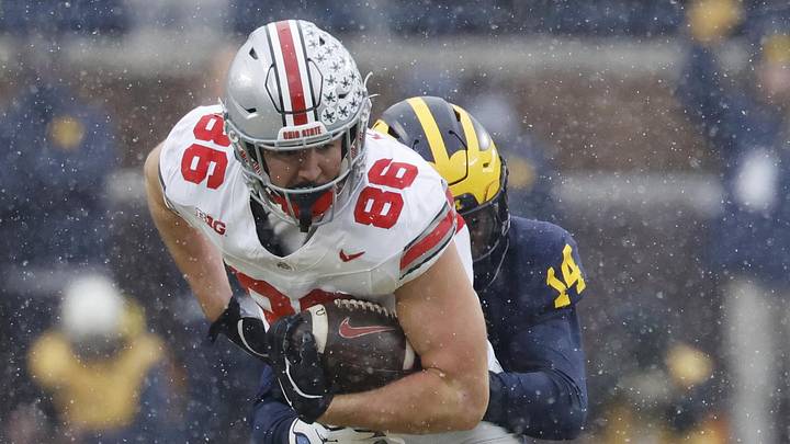 Nov 29, 2025; Ann Arbor, Michigan, USA;  Ohio State Buckeyes tight end Max Klare (86) is tackled by Michigan Wolverines defensive back Jordan Young (14) at Michigan Stadium. Mandatory Credit: Rick Osentoski-Imagn Images