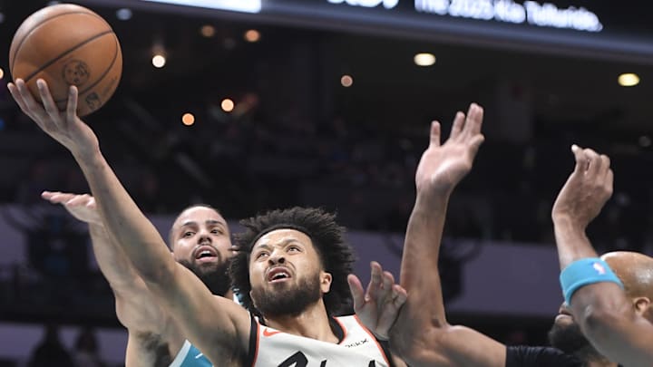Nov 21, 2024; Charlotte, North Carolina, USA;  Detroit Pistons guard Cade Cunningham (2) drives in and scores during the first half against the Charlotte Hornets at the Spectrum Center. Mandatory Credit: Sam Sharpe-Imagn Images