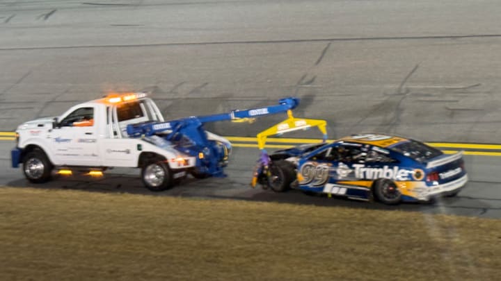 Corey LaJoie's No. 99 RFK Racing Ford gets towed away from the scene of a last-lap crash in Thursday's America 250 Duel No. 1 at Daytona.