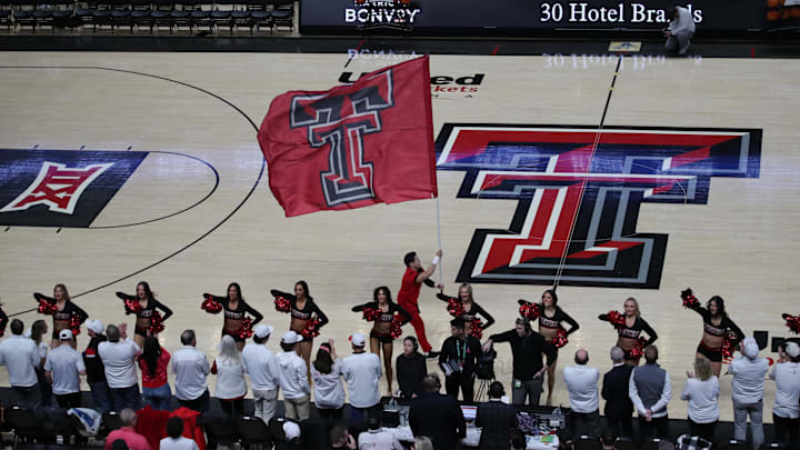 Feb 12, 2024; Lubbock, Texas, USA;  A Texas Tech Red Raiders cheerleader runs onto the court before the game against the Kansas Jayhawks at United Supermarkets Arena. Mandatory Credit: Michael C. Johnson-Imagn Images
