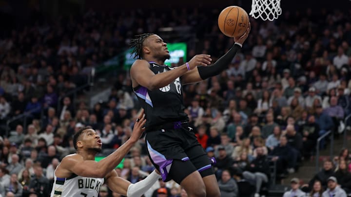 Jan 27, 2025; Salt Lake City, Utah, USA;  Utah Jazz guard Isaiah Collier (13) shoots a layup as Milwaukee Bucks forward Giannis Antetokounmpo (34) defends during the second half against the Milwaukee Bucks at Delta Center. Mandatory Credit: Chris Nicoll-Imagn Images
