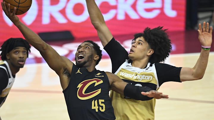Feb 11, 2026; Cleveland, Ohio, USA; Cleveland Cavaliers guard Donovan Mitchell (45) drives to the basket beside Washington Wizards forward Kyshawn George (18) in the first quarter at Rocket Arena. Mandatory Credit: David Richard-Imagn Images