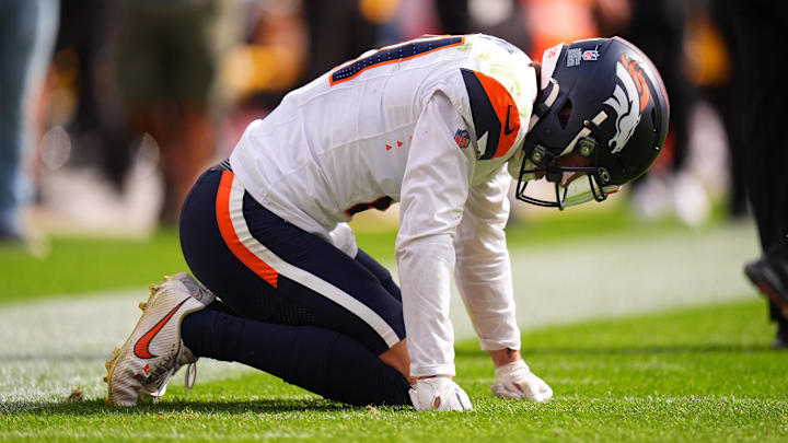 Sep 15, 2024; Denver, Colorado, USA; Denver Broncos cornerback Riley Moss (21) reacts to an injury after a tackle in the second quarter against the Pittsburgh Steelers at Empower Field at Mile High. Sep 15, 2024; Denver, Colorado, USA; Denver Broncos cornerback Riley Moss (21) reacts to an injury after a tackle in the second quarter against the Pittsburgh Steelers at Empower Field at Mile High.