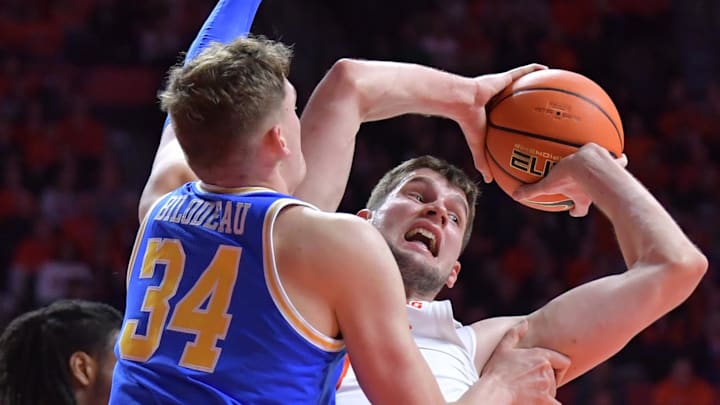 Feb 11, 2025; Champaign, Illinois, USA;  Illinois Fighting Illini center Tomislav Ivisic (13) is pressured by UCLA Bruins forward Tyler Bilodeau (34) during the first half at State Farm Center. Mandatory Credit: Ron Johnson-Imagn Images