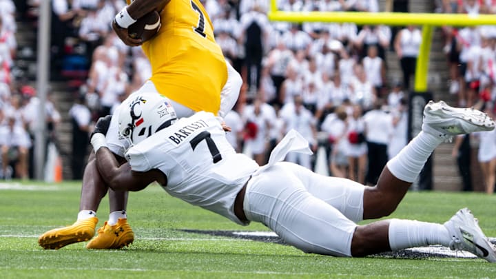 Cincinnati Bearcats linebacker Jared Bartlett (7) tackles Towson Tigers defensive back Kam Snell (7) in the first quarter of the College Football game at Nippert Stadium in Cincinnati on Saturday, Aug. 31, 2024. Cincinnati Bearcats linebacker Jared Bartlett (7) tackles Towson Tigers defensive back Kam Snell (7) in the first quarter of the College Football game at Nippert Stadium in Cincinnati on Saturday, Aug. 31, 2024.