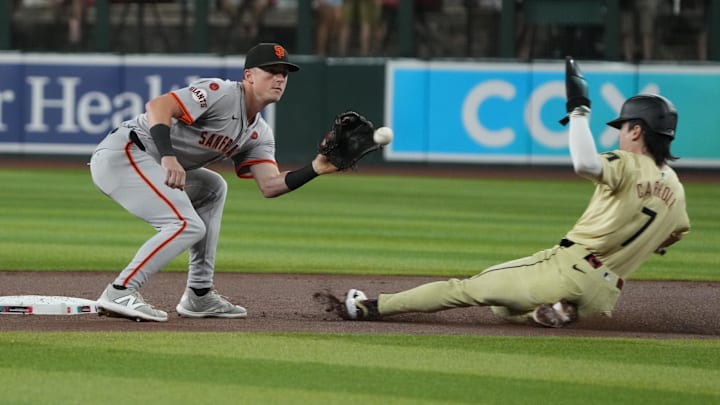 Sep 24, 2024; Phoenix, Arizona, USA; Arizona Diamondbacks outfielder Corbin Carroll (7) slides into second base in front of San Francisco Giants shortstop Brett Wisely (0) in the first inning at Chase Field. Mandatory Credit: Rick Scuteri-Imagn Images Sep 24, 2024; Phoenix, Arizona, USA; Arizona Diamondbacks outfielder Corbin Carroll (7) slides into second base in front of San Francisco Giants shortstop Brett Wisely (0) in the first inning at Chase Field. Mandatory Credit: Rick Scuteri-Imagn Images
