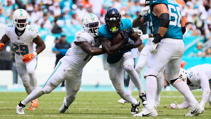 Jacksonville Jaguars running back Tank Bigsby (4) runs with the football against Miami Dolphins linebacker David Long Jr. (11) during the third quarter at Hard Rock Stadium.