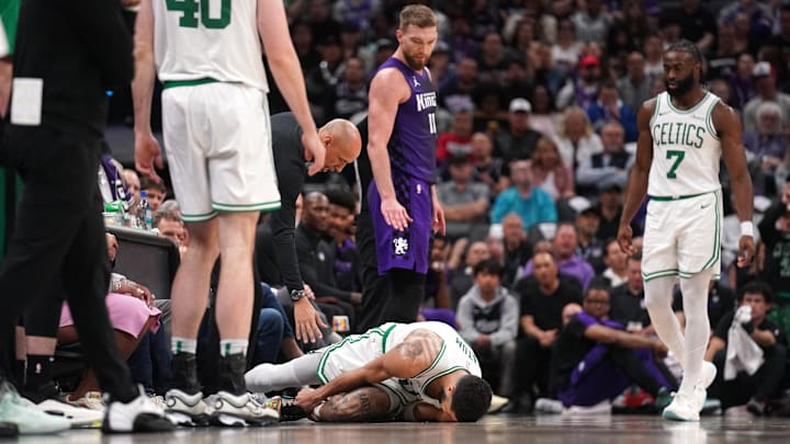 Mar 24, 2025; Sacramento, California, USA; Boston Celtics forward Jayson Tatum (0) lays on the ground after suffering an injury next to Sacramento Kings center Domantas Sabonis (11) in the third quarter at the Golden 1 Center. Mandatory Credit: Cary Edmondson-Imagn Images Mar 24, 2025; Sacramento, California, USA; Boston Celtics forward Jayson Tatum (0) lays on the ground after suffering an injury next to Sacramento Kings center Domantas Sabonis (11) in the third quarter at the Golden 1 Center. Mandatory Credit: Cary Edmondson-Imagn Images