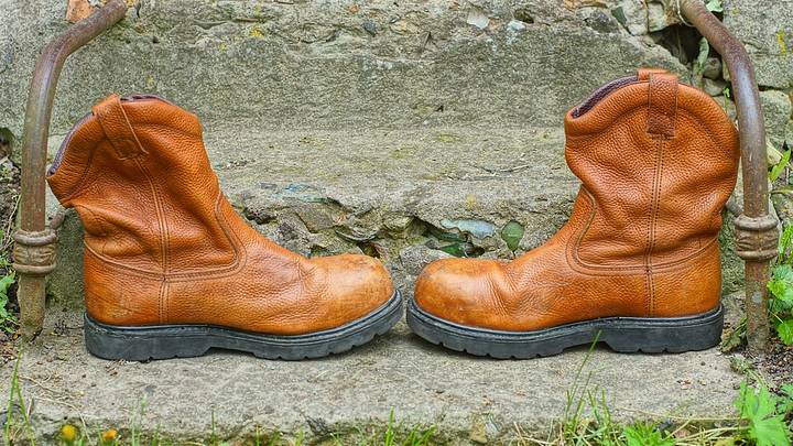Cowboy boots against stone stairs Cowboy boots against stone stairs
