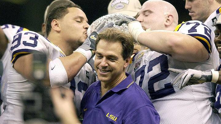 Jan. 4, 2004; New Orleans, LA, USA; Head Coach Nick Saban smiles as Chad Lavalais (# 93, left) and Stephen Peterman (#72) kiss the ADT National Championship Trophy after winning the 2004 Nokia Sugar Bowl defeating Oklahoma 21-14; Mandatory credit: Douglas Collier-USA TODAY NETWORK
Jan. 4, 2004; New Orleans, LA, USA; Head Coach Nick Saban smiles as Chad Lavalais (# 93, left) and Stephen Peterman (#72) kiss the ADT National Championship Trophy after winning the 2004 Nokia Sugar Bowl defeating Oklahoma 21-14; Mandatory credit: Douglas Collier-USA TODAY NETWORK