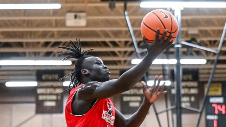 Team Goodfellas' and Michigan State's Kur Teng scores against Team Motorcars in the game on Thursday, June 27, 2024, during the Moneyball Pro-Am at Holt High School.