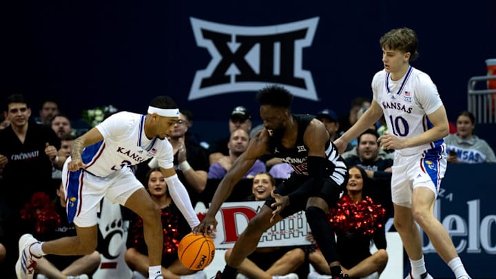 Cincinnati Bearcats forward John Newman III (15) and Kansas Jayhawks guard Dajuan Harris Jr. (3)