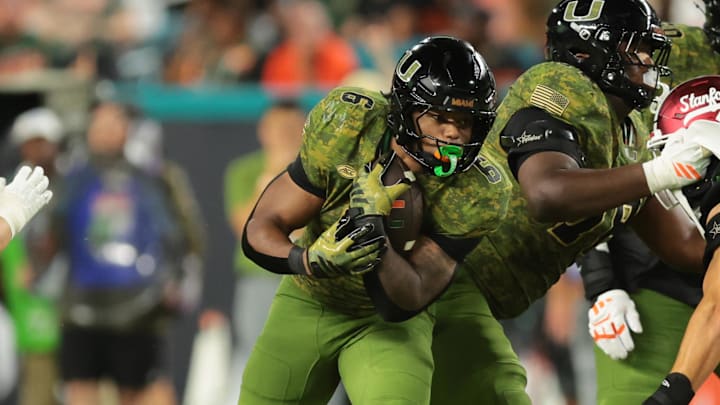 Oct 25, 2025; Miami Gardens, Florida, USA; Miami Hurricanes running back Charmar Brown (6) carries the football as offensive lineman Matthew McCoy (78) blocks Stanford Cardinal linebacker Hunter Barth (23) during the second quarter at Hard Rock Stadium. Mandatory Credit: Sam Navarro-Imagn Images