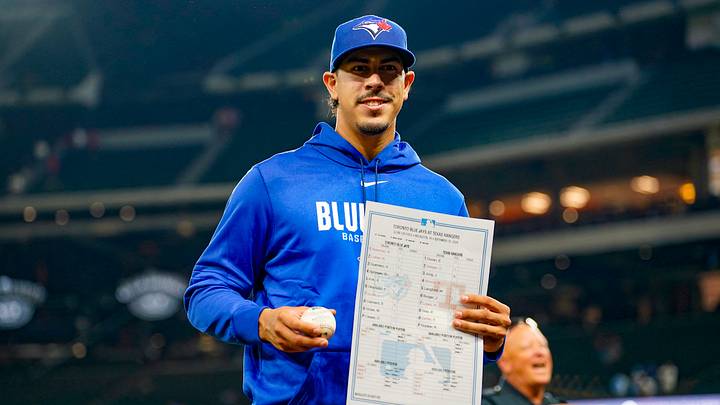 Sep 18, 2026; Arlington, Texas, USA;  Toronto Blue Jays pitcher Jose Rodriguez (64), who made is MLB debut in the sixth inning, holds a baseball and lineup card from the game against the Texas Rangers at Globe Life Field. Mandatory Credit: Raymond Carlin III-Imagn Images