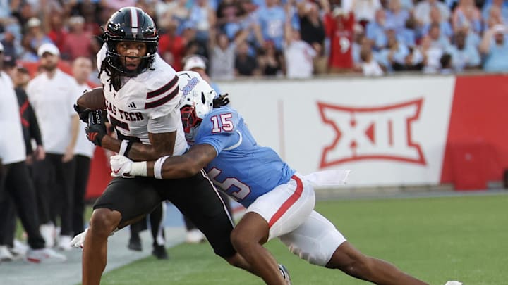 Oct 4, 2025; Houston, Texas, USA; Texas Tech Red Raiders wide receiver Caleb Douglas (5) is tackled by Houston Cougars defensive back Will James (15) in the first half at TDECU Stadium. Mandatory Credit: Thomas Shea-Imagn Images