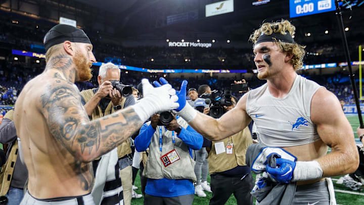 Detroit Lions defensive end Aidan Hutchinson, right, and Las Vegas Raiders defensive end Maxx Crosby exchange jerseys 