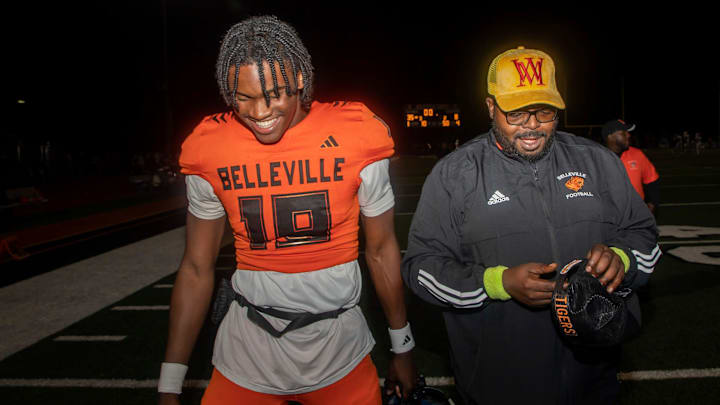 Belleville quarterback Bryce Underwood (19) walks next to one of his coaches, LeeAndrew Omorogieva, at the end of a 35-8 victory against Westland Glenn in Belleville on Friday, Sept. 29, 2023. Belleville quarterback Bryce Underwood (19) walks next to one of his coaches, LeeAndrew Omorogieva, at the end of a 35-8 victory against Westland Glenn in Belleville on Friday, Sept. 29, 2023.
