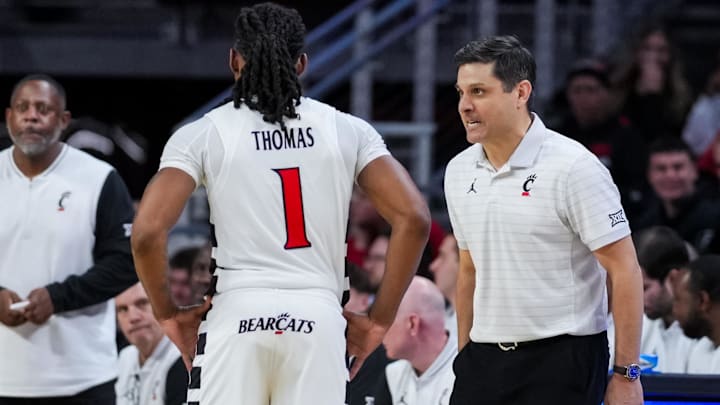 Dec 1, 2025; Cincinnati, Ohio, USA;  Cincinnati Bearcats head coach Wes Miller talks with guard Day Day Thomas (1) during a stop in play against the Tarleton State Texans in the second half at Fifth Third Arena. Mandatory Credit: Aaron Doster-Imagn Images