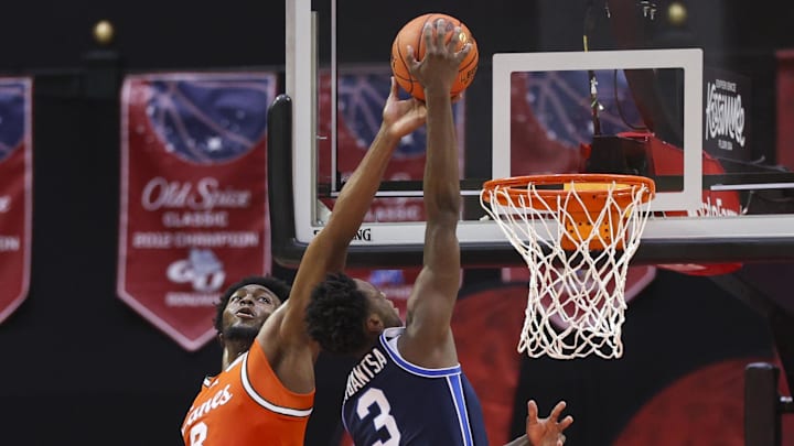 Nov 27, 2025; Kissimmee, Florida, USA; Miami (FL) Hurricanes center Ernest Udeh Jr. (8) blocks a shot from Brigham Young University Cougars forward AJ Dybantsa (3) in the first half at State Farm Field House. Mandatory Credit: Nathan Ray Seebeck-Imagn Images