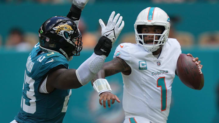 Miami Dolphins quarterback Tua Tagovailoa (1) rolls out to pass as linebacker Foyesade Oluokun (23) follows on the play at Hard Rock Stadium. Miami Dolphins quarterback Tua Tagovailoa (1) rolls out to pass as linebacker Foyesade Oluokun (23) follows on the play at Hard Rock Stadium.