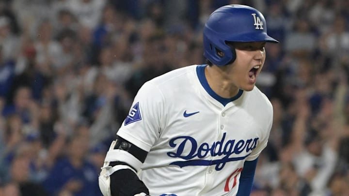 Sep 26, 2024; Los Angeles, California, USA;  Los Angeles Dodgers designated hitter Shohei Ohtani (17) celebrates as he runs to first after he singled in the go ahead run in the seventh inning against the San Diego Padres at Dodger Stadium. Mandatory Credit: Jayne Kamin-Oncea-Imagn Images