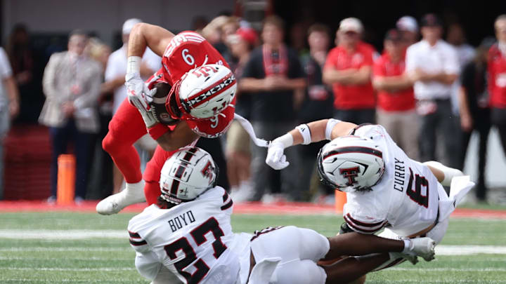 Sep 20, 2025; Salt Lake City, Utah, USA; Utah Utes wide receiver Ryan Davis (9) is tackled by Texas Tech Red Raiders defensive back Amier Boyd (27) and linebacker John Curry (6) during the first quarter at Rice-Eccles Stadium. Mandatory Credit: Rob Gray-Imagn Images
